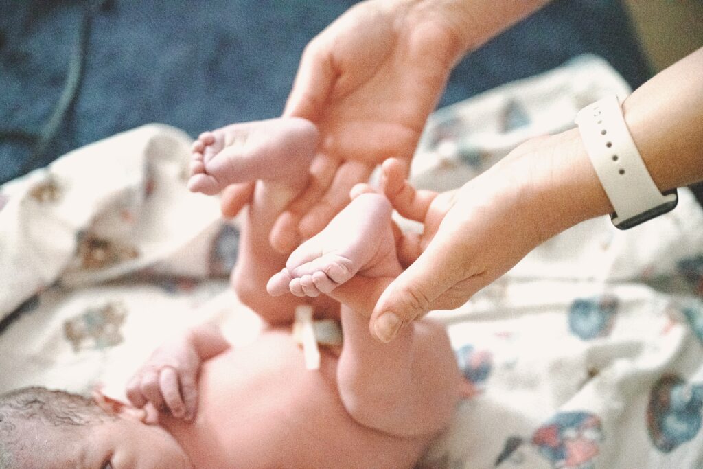 Midwife doing a newborn exam on a baby born at home